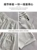 Calça de moletom roxa estilo americano com barra curva para mulheres, novo modelo de outono de 2026, casual e relaxada, corte solto, afina a silhueta, calça esportiva de perna larga