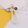 Estilo Nuevo de Primavera Chanel Perla Cadena de Mano DIY Hecho a Mano Bolso Casero Funda para Teléfono Móvil Llavero Accesorios
