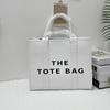 A Bolsa Tote média Nova Moda grande capacidade portátil Bolsa Tote feminina simples versátil ombro mensageiro Bolsa