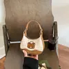 Bolso de cuadros de nicho exquisito y moderno para mujer, nuevo modelo 2026, minibolso cruzado versátil, bolso tipo dumpling, bolso de mano pequeño para salir