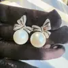 Pendientes de Lazo con Perlas y Aguja de Plata S999, Modernos y Versátiles, Diseño de Nicho, Gama Alta, Lujo Ligero, Pendientes Elegantes y Únicos