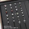 Nuevos y modernos aretes de cruz con diamantes completos Jiuhan para mujer, ear cuffs de acero de titanio de nicho, populares tachuelas de hueso de la oreja de alta gama
