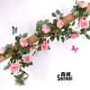 Simulación de vid de rosa, flor falsa de plástico, vid de hoja verde, planta de flor, vid de boda, decoración del hogar, vid de flores al por mayor