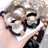 Corea del Sur Dongdaemun banda de goma color té de leche textura bola anillo elástico para toalla banda para el pelo moda simple temperamento cuerda para el pelo