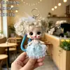 Nuevo llavero de muñeca de maquillaje con temática de fresa de la fábrica original, con un diseño lindo, cordón de silicona colorido y ojos grandes, perfecto como regalo para niñas