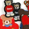 Bordado de computadora logo animal pequeño de dibujos animados oso zapatos y sombreros bolsa accesorios accesorios de ropa parche insignia tela bordada pegatinas