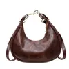Bolso de axila para el día a día con un toque de alta gama, diseño de nicho, colgante de cereza, bolso cruzado para mujer, nuevo bolso francés de media luna 2026
