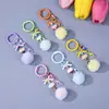Llavero de pompón de colores correa para teléfono móvil colgante de bola de felpa DIY accesorio de decoración de lazo al por mayor del fabricante