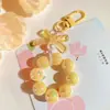 Llavero Colgante de Coche con Lazo de Perlas Electrochapado Color Caramelo Pintura para Hornear Hebilla Pequeña para Puerta Accesorios de Perla Bolsa