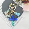 Venta al por mayor de fábrica Llavero con borla de mariposa de flor seca para cruzar Colgante para bolso Llavero retro europeo y americano para mujer