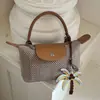 Bolso tejido de moda de verano transfronterizo 2026 nuevo bolso de mano casual para mujer, bolso de hombro y bandolera versátil, moderno y único