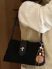 Bolso pequeño cuadrado de color sólido retro de alto valor para mujer, nuevo estilo de otoño 2026, bolso de mano de hombro moderno y elegante