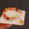 Pulsera nueva china de piedra natural jade dorado con cuentas lirio mariposa orquídea pulsera antigua de alto sentido joyería de mano al por mayor