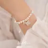 Pulsera de cordón ajustable con flor de circón y perla de estilo francés, una pieza de joyería lujosa y elegante que es tanto dulce como versátil