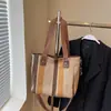 Bolso de mujer de comercio exterior, nuevo bolso de lona a rayas de moda 2025, bolso de hombro de gran capacidad, bolso bandolera portátil para uso diario.