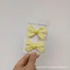 Pin para el pelo de niña estudiante con temperamento dulce, borde de oreja de madera amarillo claro, pinza de par de lazo pequeño, pinza de borde, pinza para flequillo