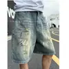 Pantalones cortos de mezclilla casual de estilo americano para hombre, frescos, retro, desgastados, rotos, holgados y versátiles, pantalones de cinco puntos de moda callejera