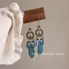 Pendientes largos con borlas y plumas en forma de gota de agua para mujer, estilo bohemio, con cuentas de arroz, estilo europeo y americano, accesorios de turismo y vacaciones.