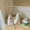 Shuai Mijia Bolsa Tote de Grande Capacidade Feminina Verão 2026 Nova Moda para o Trabalho Bolsa de Ombro Único Mochila Casual Elegante Tendência
