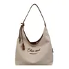 Bolsa de lona simples de grande capacidade para mulheres, nova moda 2026, bolsa de ombro com letra bordada, bolsa tote casual para o dia a dia