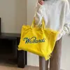 Bolso de lona con letra y borla minimalista para comercio exterior, bolso de mano de gran capacidad, nuevo bolso tote de hombro de color liso para uso transfronterizo