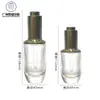 En stock ventas directas 30ml50ml cuerpo de botella triangular esencia aceite esencial botella gotero de presión giratoria manga de hombro subempaque botella de vidrio