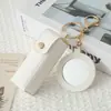 Mini llavero de lipstick portátil, bolsa redonda de cuero con espejo de maquillaje, accesorio para niñas, colgante de bolsa de espejo de maquillaje portátil