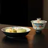 Bandeja de té de cerámica con diseño floral azul y blanco, patrón moteado rojo y forma redonda, adecuada para accesorios de ceremonia de té y uso doméstico