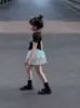 Conjunto de Verão para Meninas 2025 Novo Estiloso Camiseta Infantil de Manga Curta Moda Saia Plissada Curta Conjunto de Duas Peças Saia Bolo