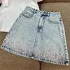 Saia Feminina 2026 Verão Saia Jeans com Lantejoulas e Miçangas Azul Claro Moda Design de Nicho Saia Evasê Saia Curta