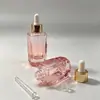 Botella de vidrio con corte facetado degradado Anillo dorado Cabezal de aplicador blanco Botella de empaque para aceite esencial para el cuidado de la piel Botella para aceite esencial para el cuidado de la piel