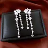 Pendientes de borla con flor de trébol de circonita vintage con un toque de alta gama, pendientes versátiles y de moda al por mayor