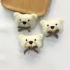 Nueva cabeza de animal de dibujos animados Muñeco de algodón tridimensional Oso con lazo Accesorios de decoración Oso festivo bufanda guantes accesorios