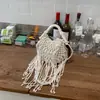 Bolso Tejido Hueco Único para Mujer 2026 Nuevo Bolso de Paja Casual para Vacaciones con Cordón, Borlas y Cuentas, Bolso Cubo de un Solo Hombro