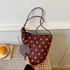 Moderna nueva colección de otoño 2026: bolso cubo de lunares de nicho para mujer, con textura similar al ante, estética retro y diseño de hombro/bajo el brazo