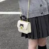 Mini bolso infantil 2026 otoño/invierno acolchado dulce cuadrado pequeño bolso de moda lazo padre-hijo PU bandolera