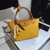 Nova bolsa de mão pequena transfronteiriça 2026 para mulheres, bolsa para o dia a dia com toque de luxo, bolsa de ombro e transversal versátil, bolsa de bolinho