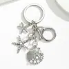Temu AliExpress Llavero Colgante Estrella de Mar Perla Vieira Cruz Europea Americana Aleación Estrella de Mar Concha Accesorios para Bolsos