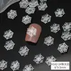 Nuevos adornos para uñas de copo de nieve navideño al por mayor hielo a través de copo de nieve tridimensional pieza blanca fina brillante decoración de uñas de resina