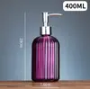 Los fabricantes suministran desinfectante de manos, botella de vidrio de patrón vertical redondo, subbotella de color, botella de vidrio transparente, botella de desinfectante de manos, botella de vidrio