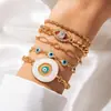 Conjunto de pulseiras multicamadas em liga metálica transfronteiriça europeia e americana, apresentando um design moderno e sofisticado com borboleta esmaltada e pedras preciosas cravejadas de diamantes