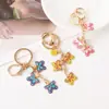 Llavero de Mariposa con Goteo de Aceite Versátil de Moda Llavero de Mariposa con Flor Colgante para Bolso de Mujer Regalos Pequeños Exquisitos Venta al por Mayor