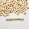 Venta al por mayor del fabricante 12mm Cuentas de Madera, Cuentas de Madera de Loto con Agujero Medio, Cuentas de Madera Sueltas, Accesorios, Ganchos para Ropa y Sombreros, Bolas Redondas de Madera de Loto