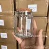 Frascos de vela personalizados con tapones de madera marrón, tazas de vela perfumada de vidrio mini de 200 ml al por mayor en stock, frascos de Biblia para DIY