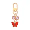 Lindo Colgante Llavero de Aleación Mariposa Colgante Creativo de Zirconia Lazo Corazón de Niña Colgante para Cubierta de Auriculares Bolsa