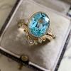 Anillo de lujo Cao Shi con diseño transfronterizo europeo y americano, corona dorada y circón azul ovalado para mujer