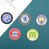 Ventas directas de fábrica de broches con el logotipo del escudo de la Liga de Campeones de la UEFA nacional, pegatinas de tela al por mayor, accesorios de ropa, accesorios decorativos
