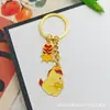Llavero Colgante Año Nuevo 2026 Metal Zodiaco León Dorado Petardo Despertar Bolsa de la Fortuna Colgante Evento Pequeño Regalo