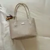 Bolso de mujer de gran capacidad, elegante, nuevo modelo de verano 2026, bandolera popular y exquisita de color liso, bolso tote para el trabajo