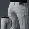 Marca europea de alta gama de moda, nuevos jeans ajustados skinny elásticos para hombre de otoño e invierno con forro polar y diseño engrosado
